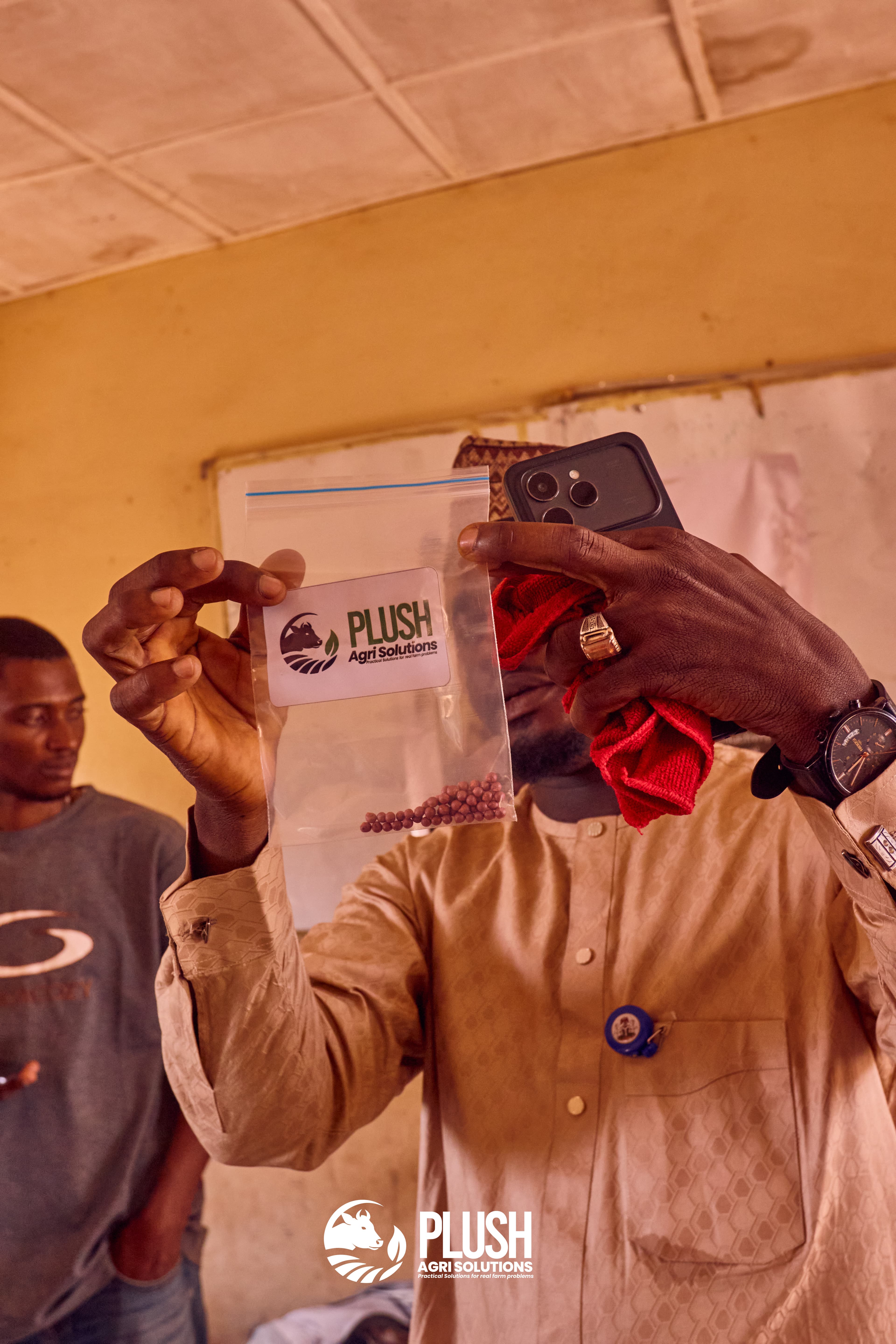 Plush Agri Solutions branded seed inputs held up at a distribution session